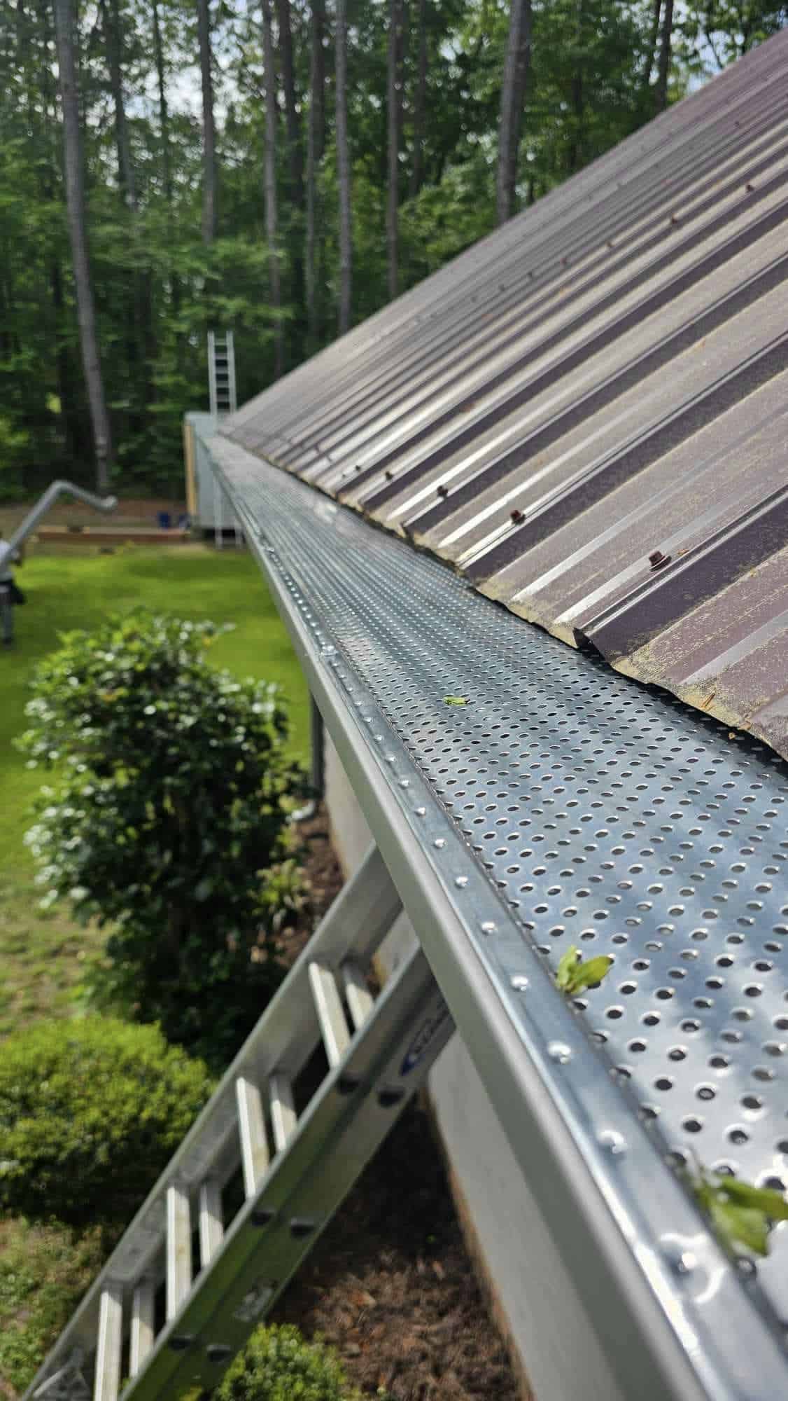 newly installed leaf guards in a metal roofing